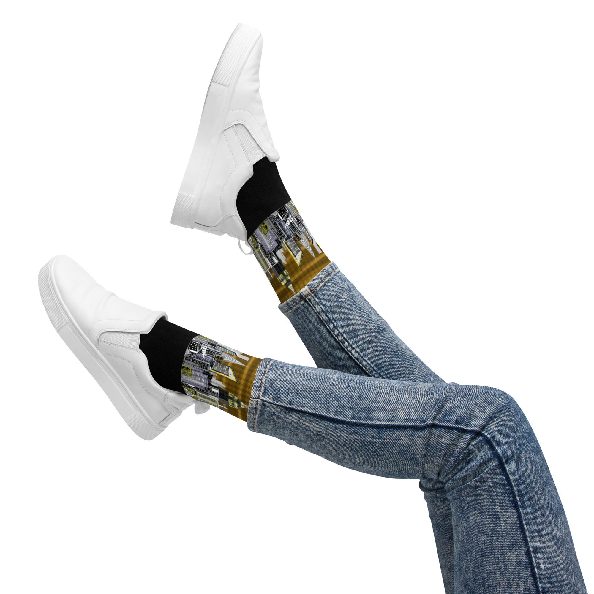 Legs wearing blue jeans, white sneakers, and black Loria NYC Art socks with a futuristic design on a white background