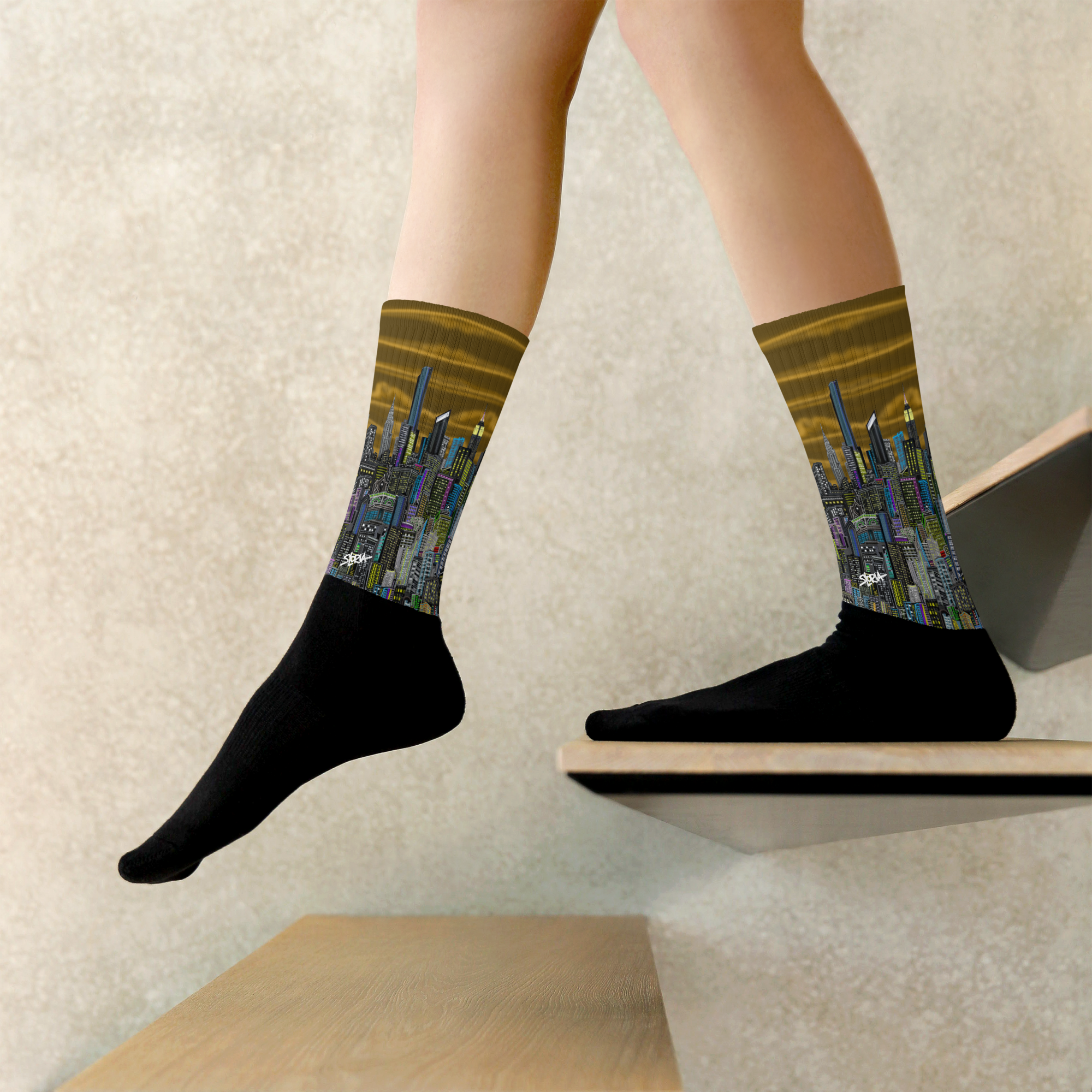 Person wearing socks with Loria NYC Art cityscape design on a neutral background