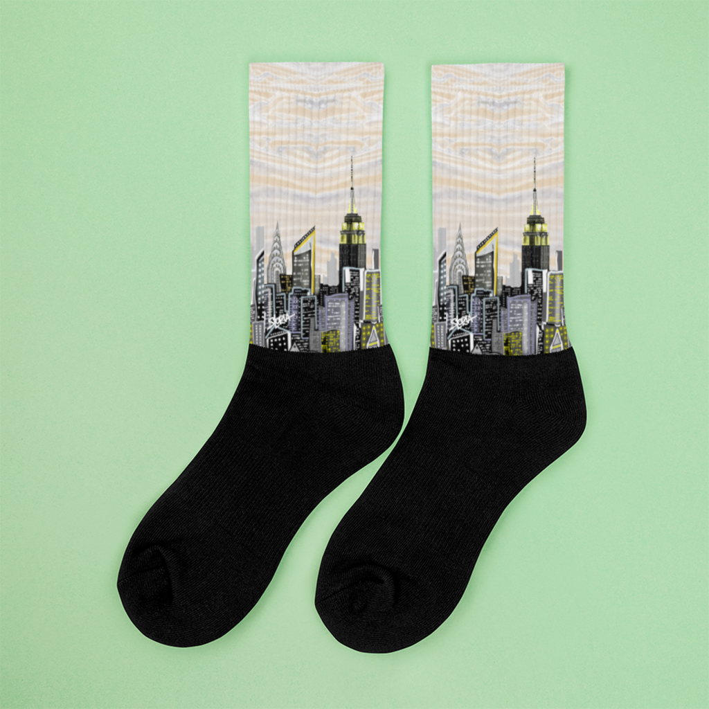 Black socks with Loria NYC Art cityscape design on a green background