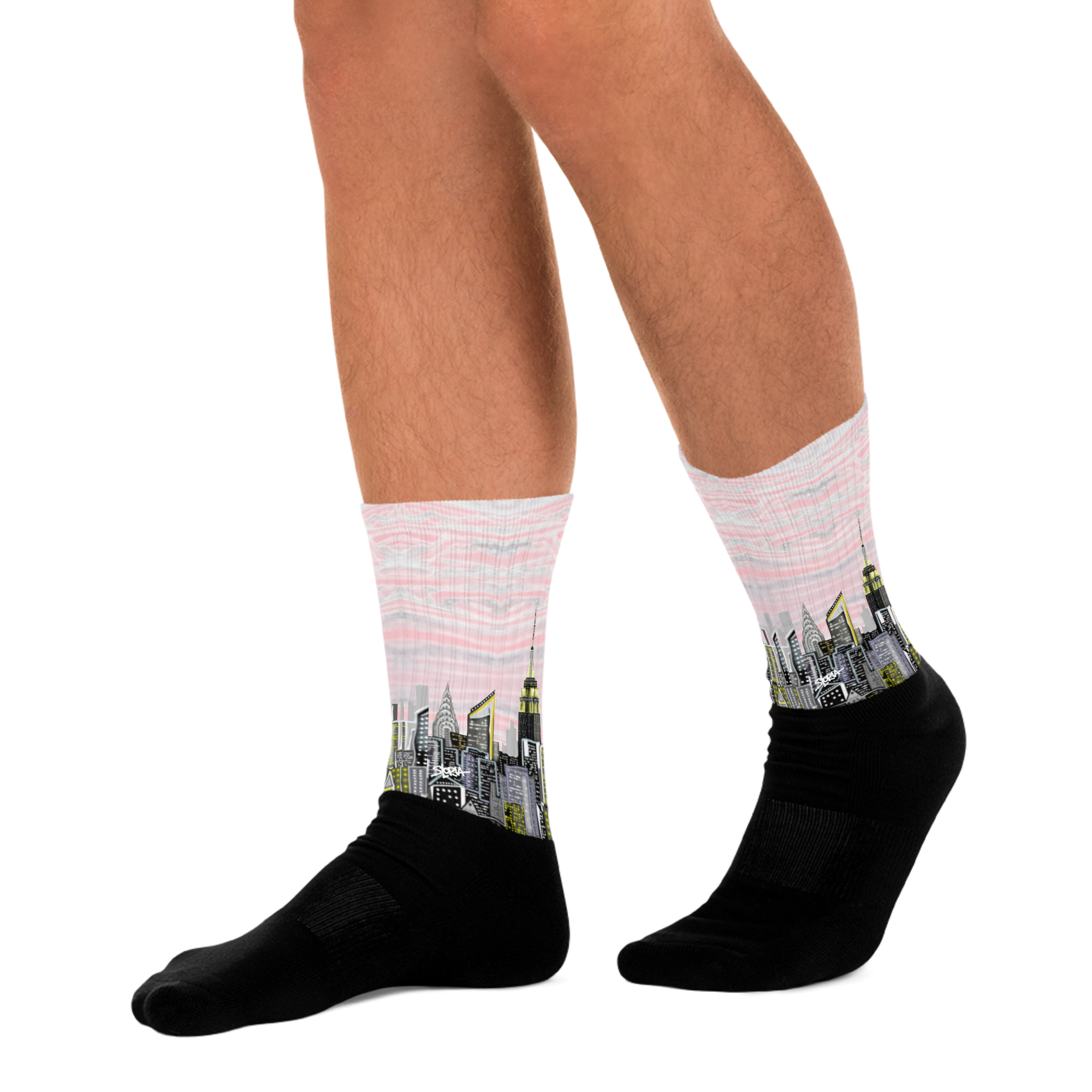Person wearing Loria NYC Art socks with cityscape design on a white background