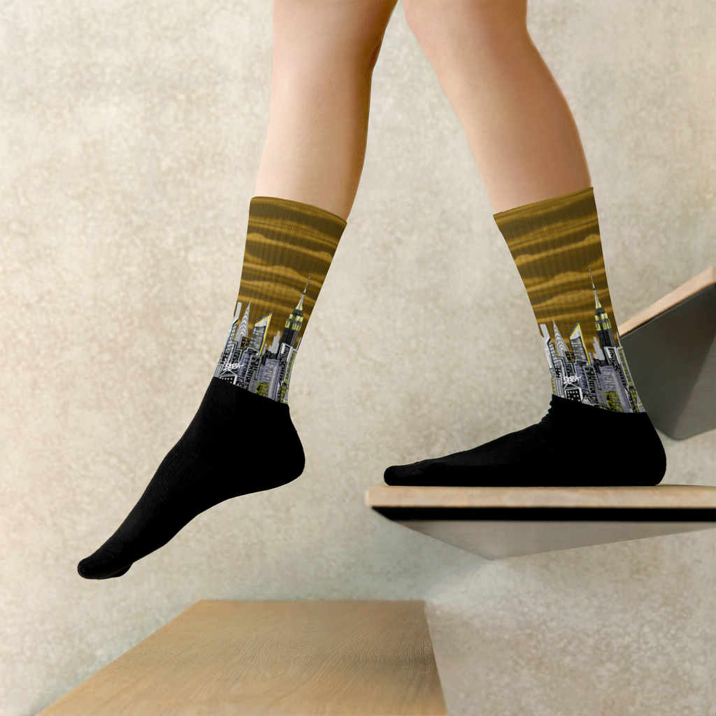 Person wearing Loria NYC Art socks with cityscape design on a neutral background