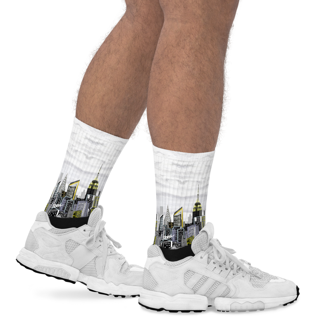 White socks with cityscape Loria NYC Art design worn with white sneakers on a white background