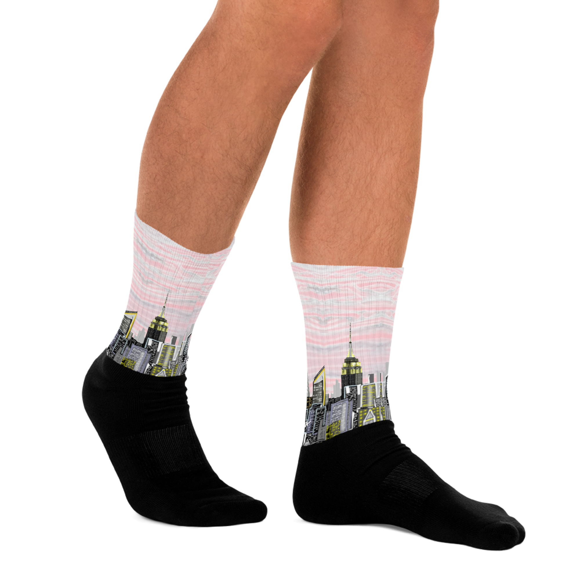 Person wearing pink Loria NYC Art socks with cityscape design on a white background