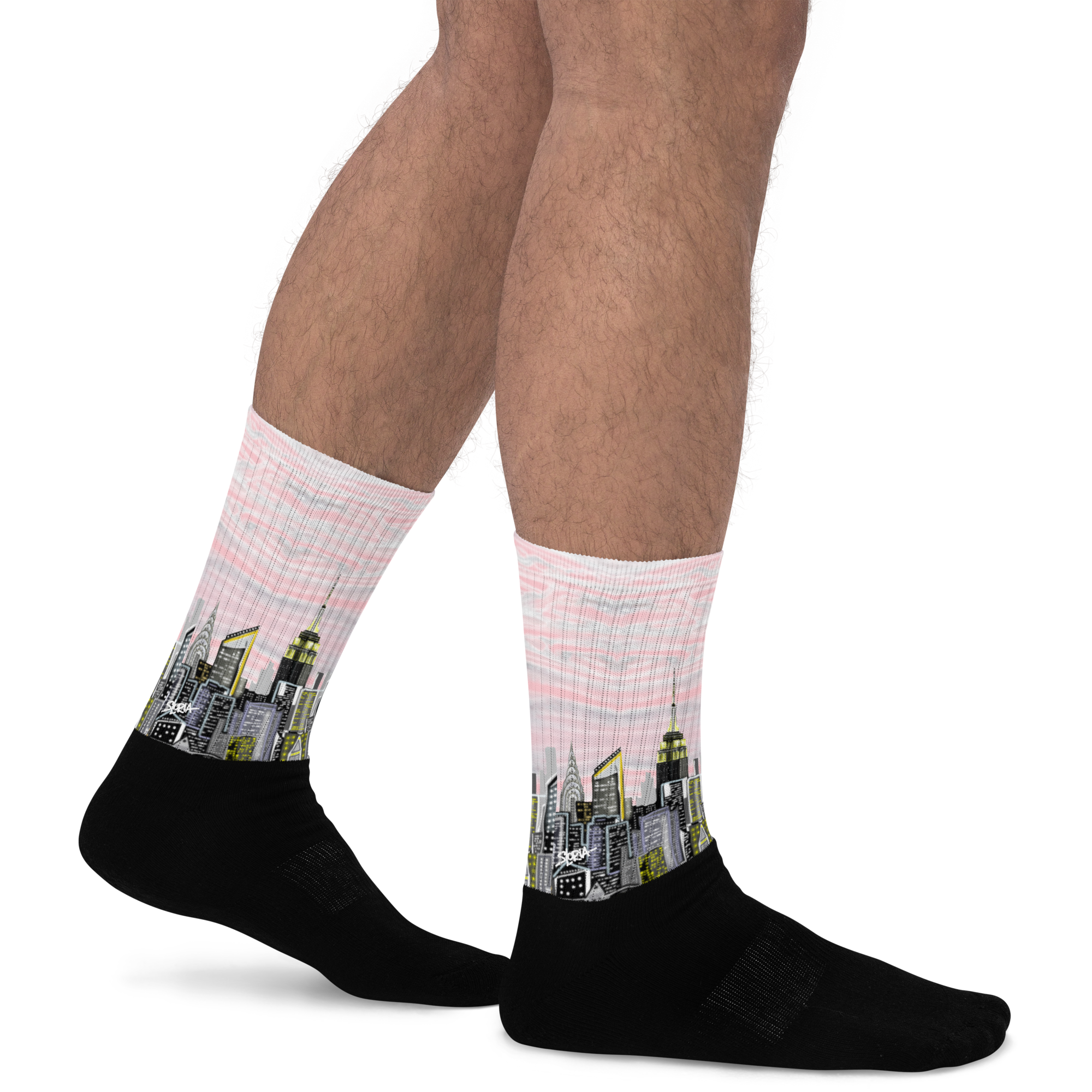Person wearing Loria NYC Art socks with cityscape design on a white background