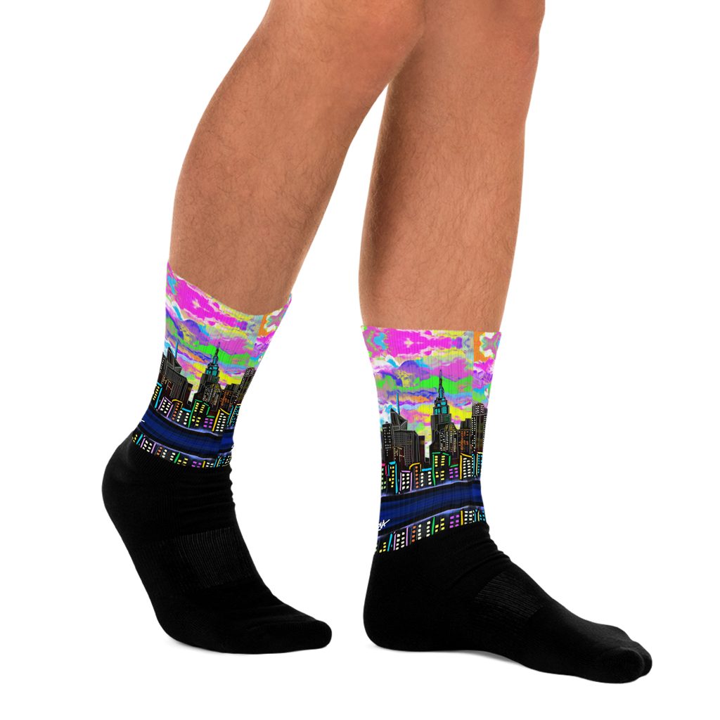 Colorful cityscape Loria NYC Art socks worn by a person on a white background