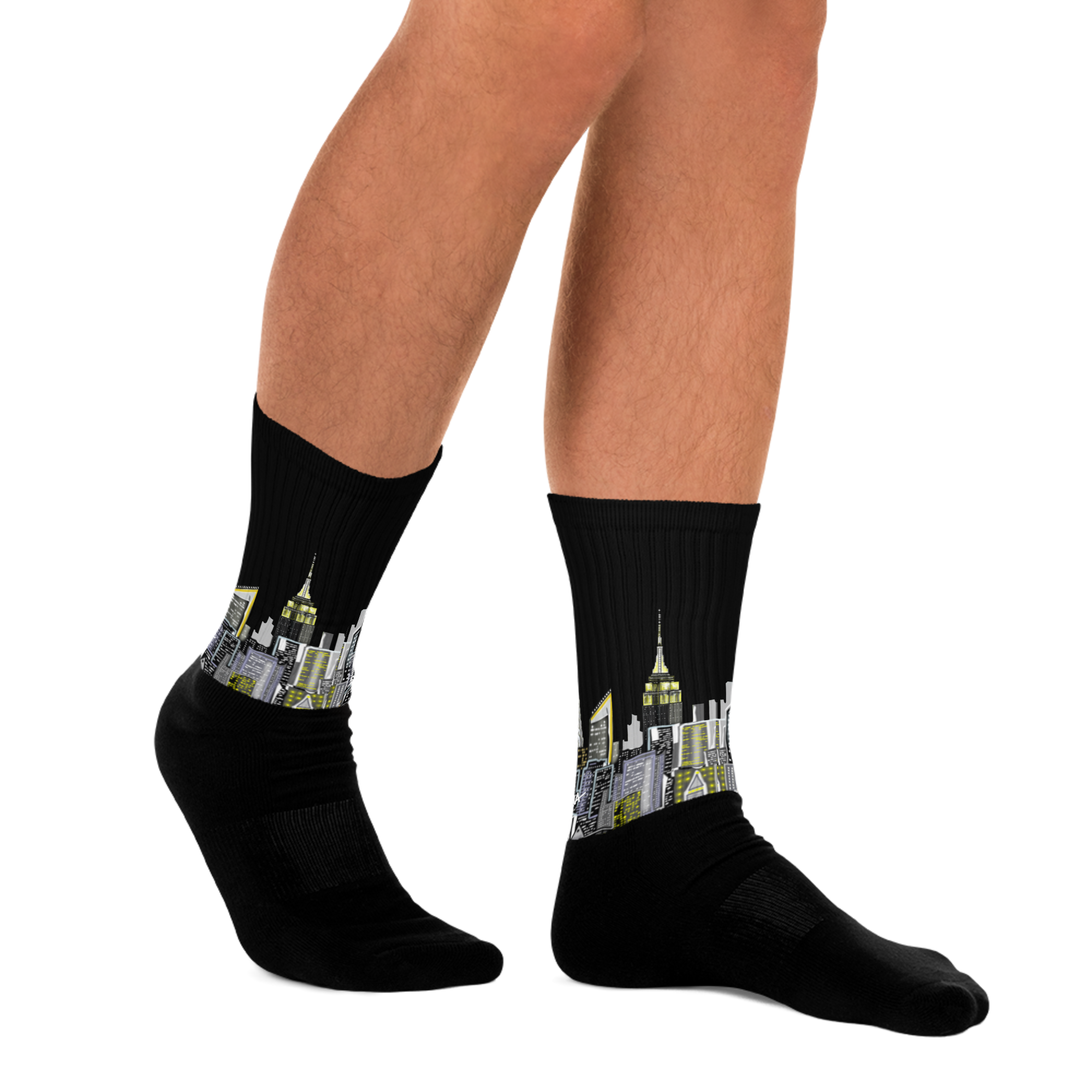 Black Loria NYC Art socks with cityscape design worn by a person on a white background