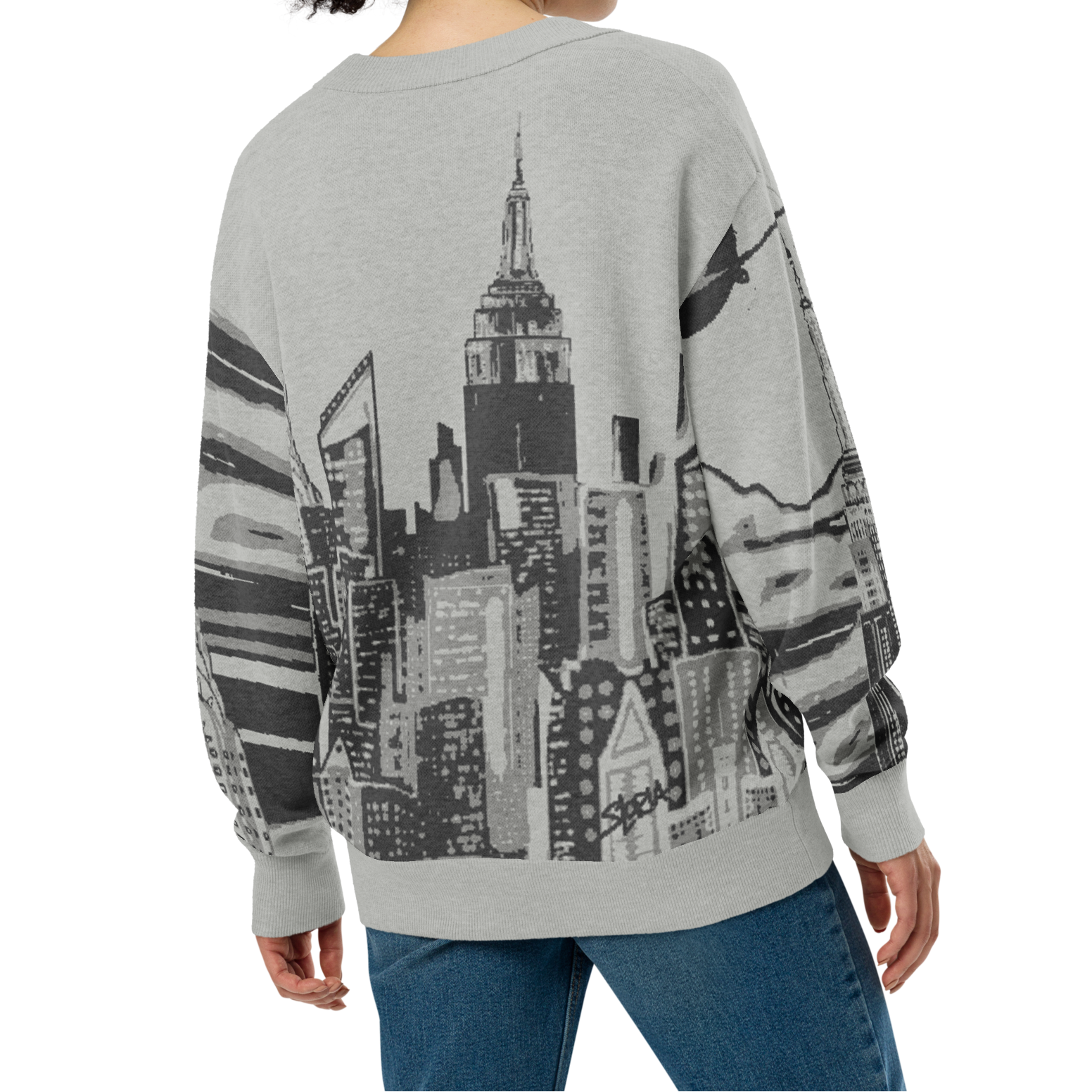 Person wearing a gray sweatshirt with a Loria NYC Art cityscape design on a white background