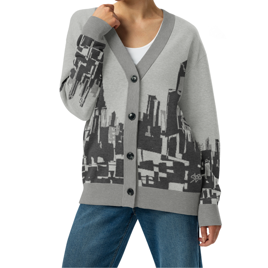 Woman wearing a gray Loria NYC Art cardigan with geometric pattern on a white background