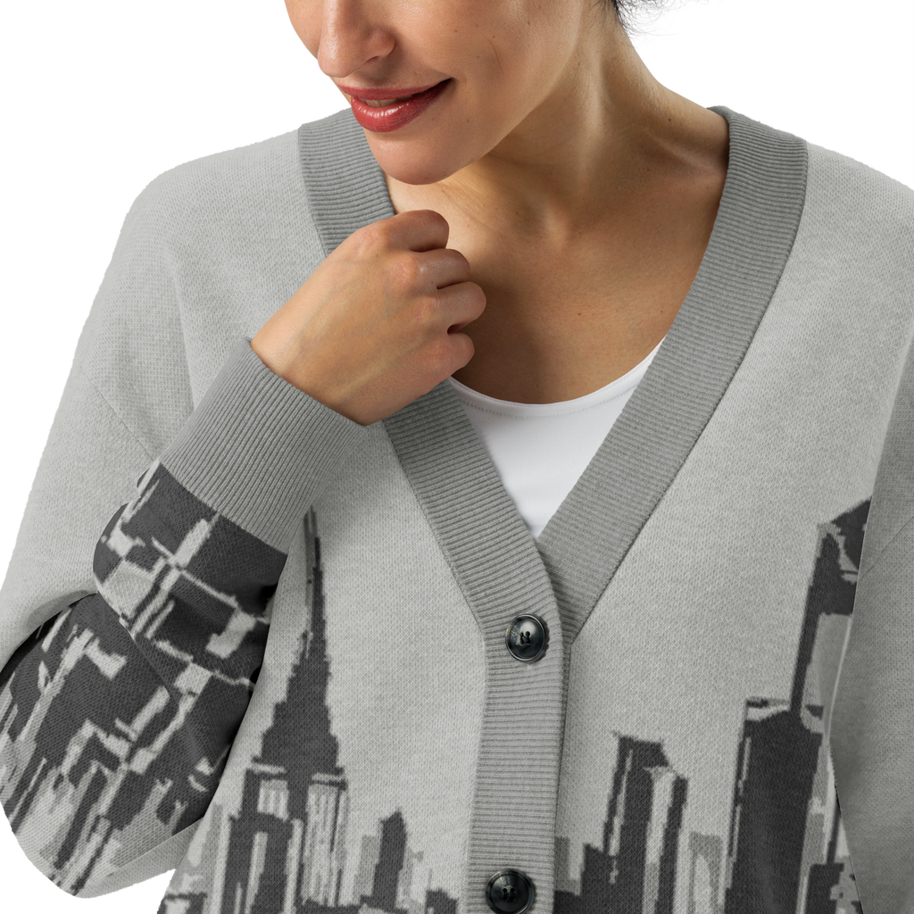 Person wearing a gray cardigan with cityscape Loria NYC Art design on a white background