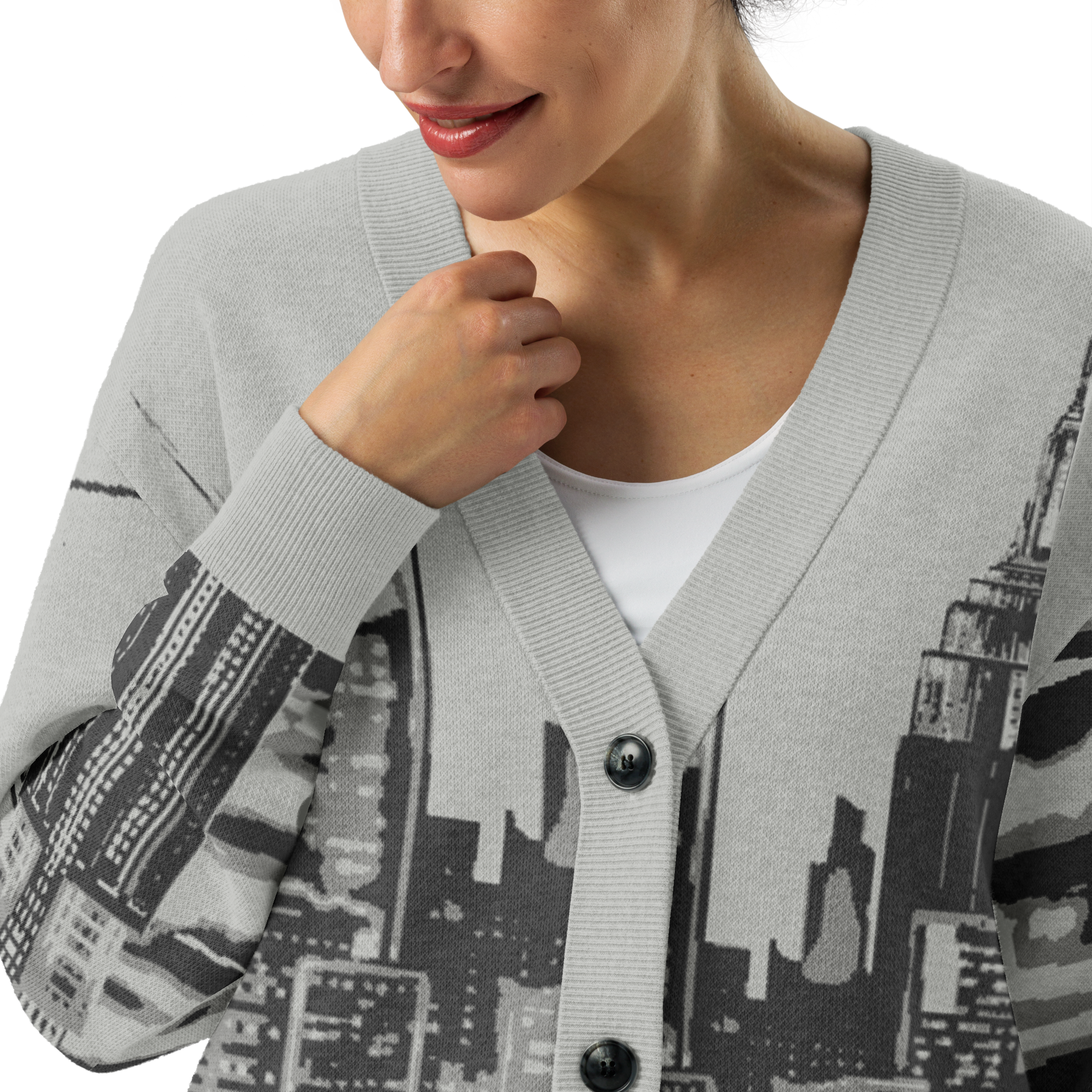 Person wearing a gray cardigan with Loria NYC Art cityscape design on a white background