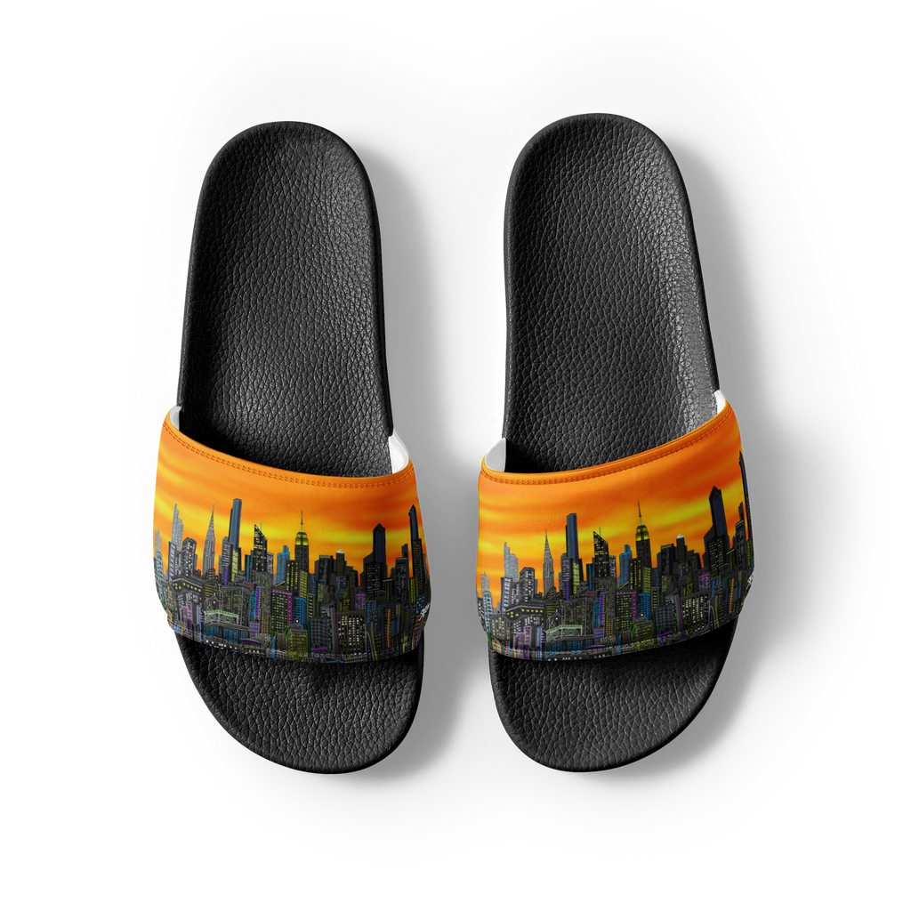Black slide sandals with a Loria NYC Art cityscape design on an orange background