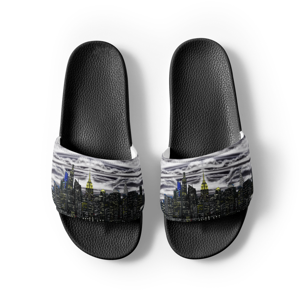 Black slide sandals with a Loria NYC Art cityscape design on a white background