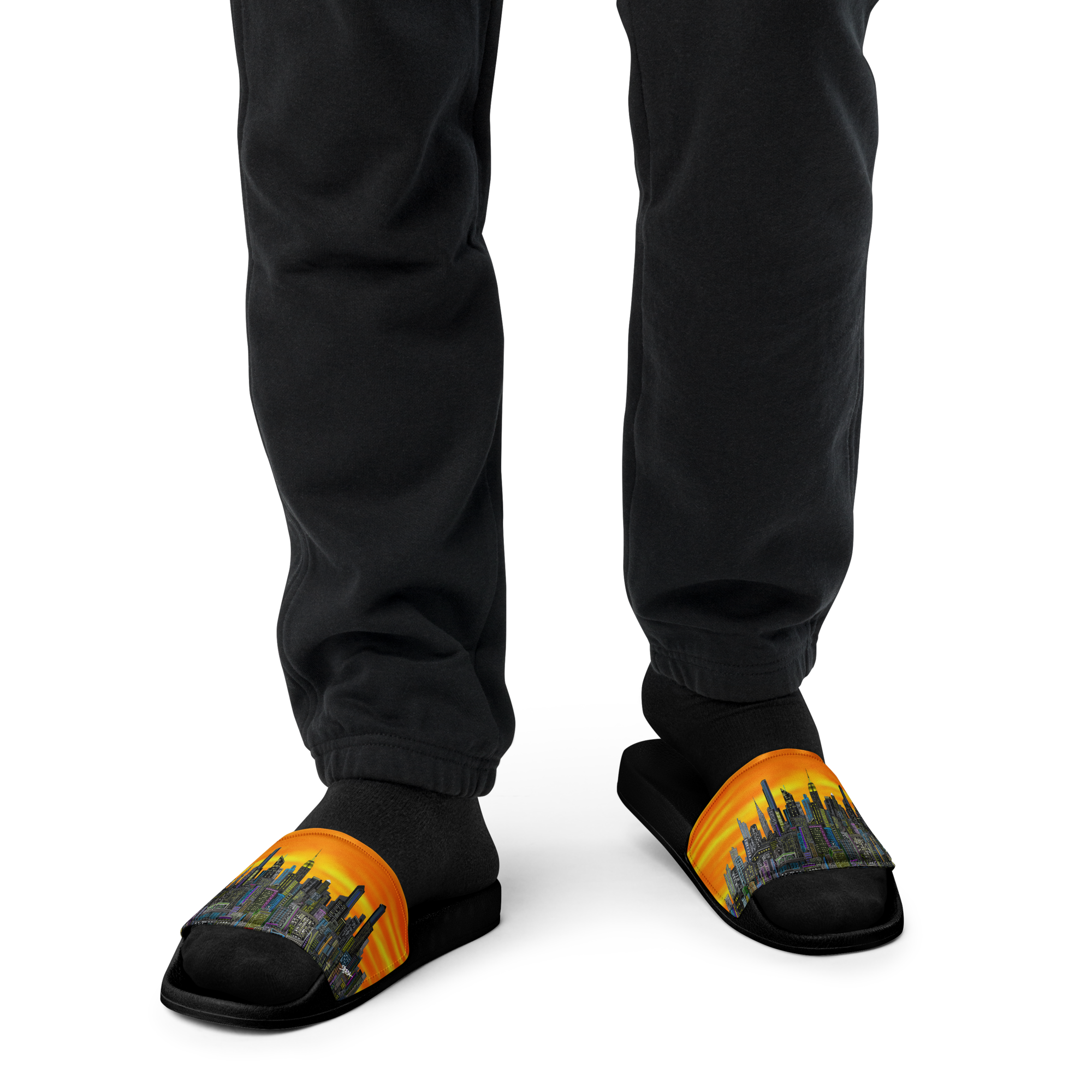 Slippers with a cityscape Loria NYC Art design worn by a person in black pants on a white background