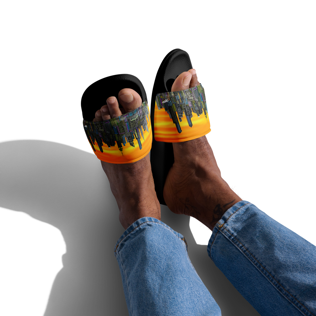 Person wearing black and orange slide sandals with a Loria NYC Art cityscape design on a white background