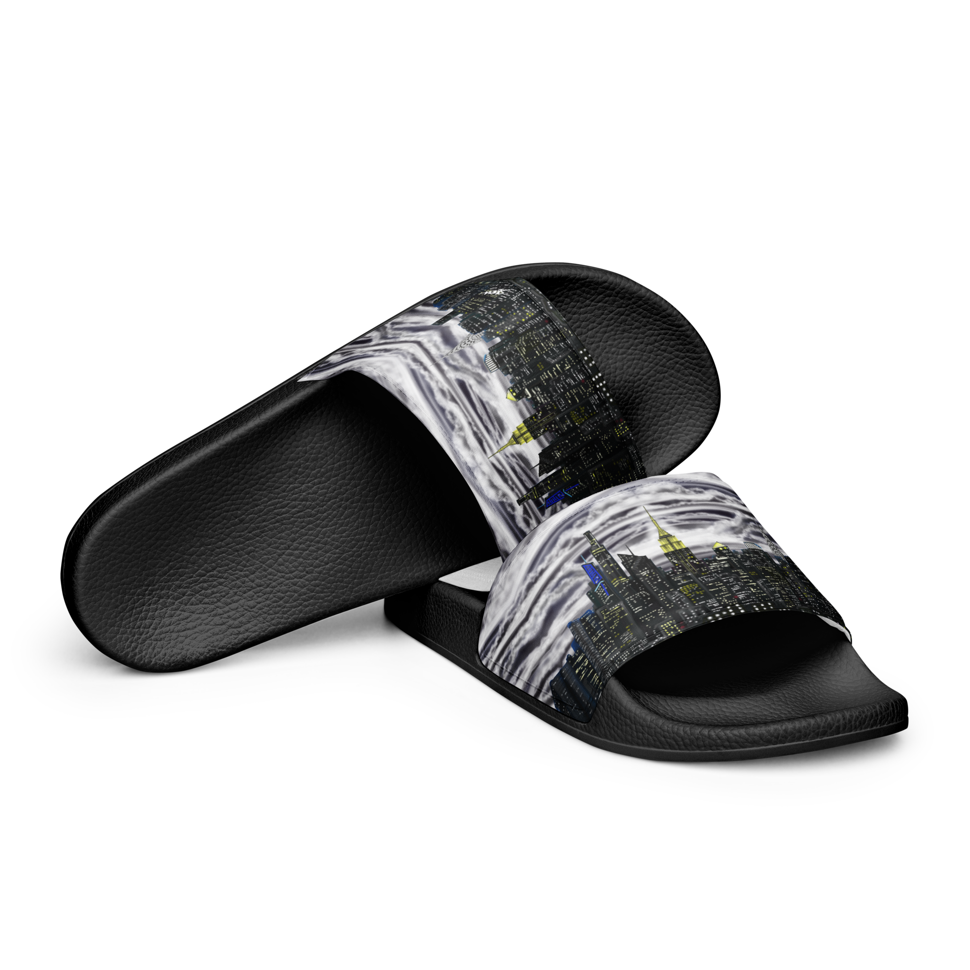 Black slide sandals with a Loria NYC Art cityscape design on a white background