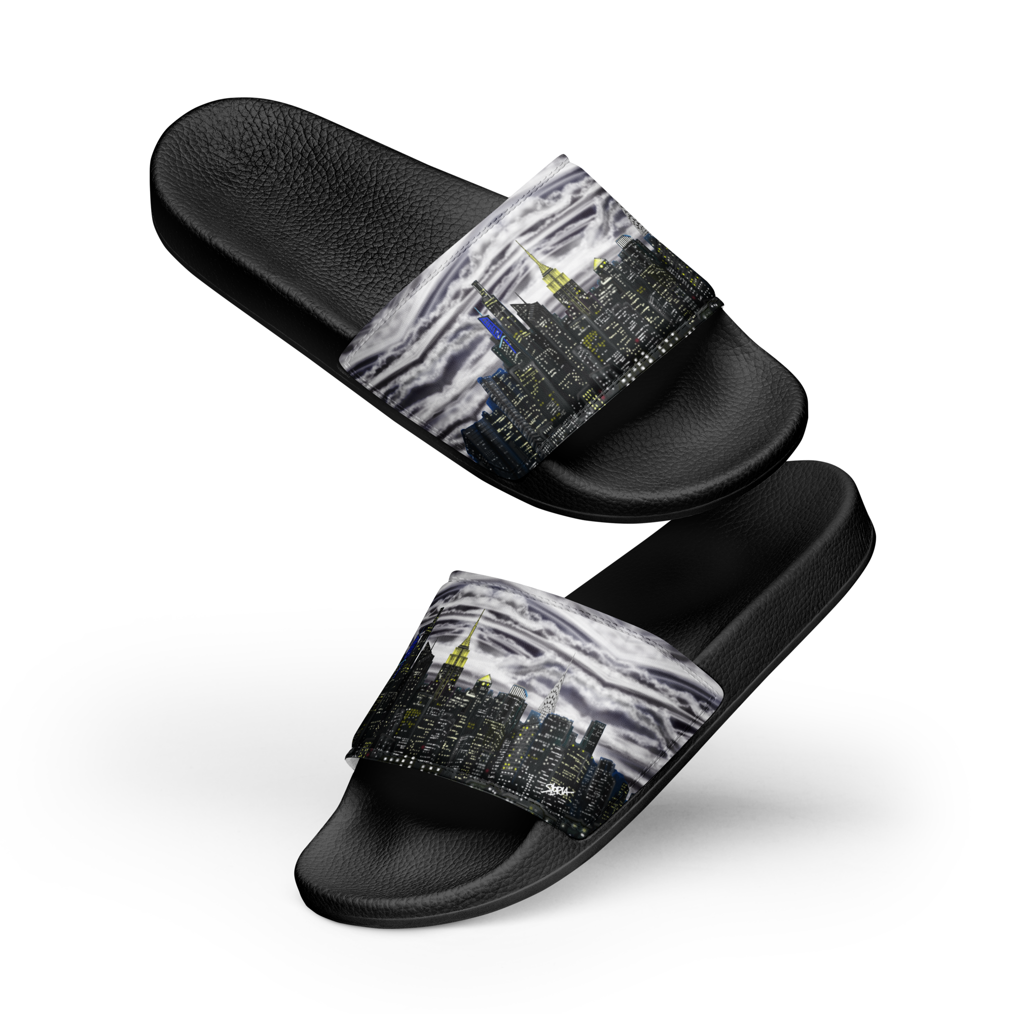 Black slide sandals with a Loria NYC Art cityscape design on a white background