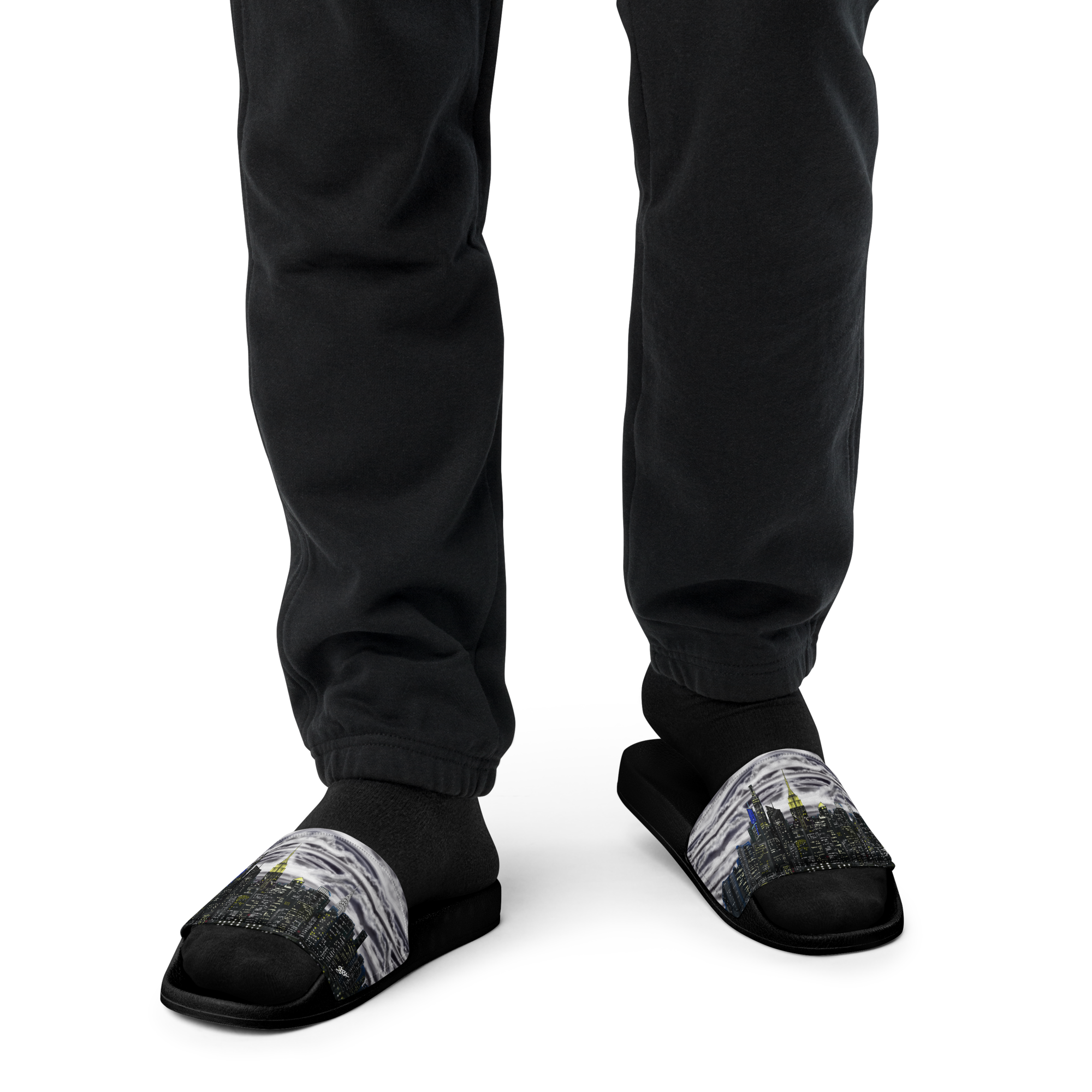 Black slippers with cityscape Loria NYC Art design worn by a person on a white background