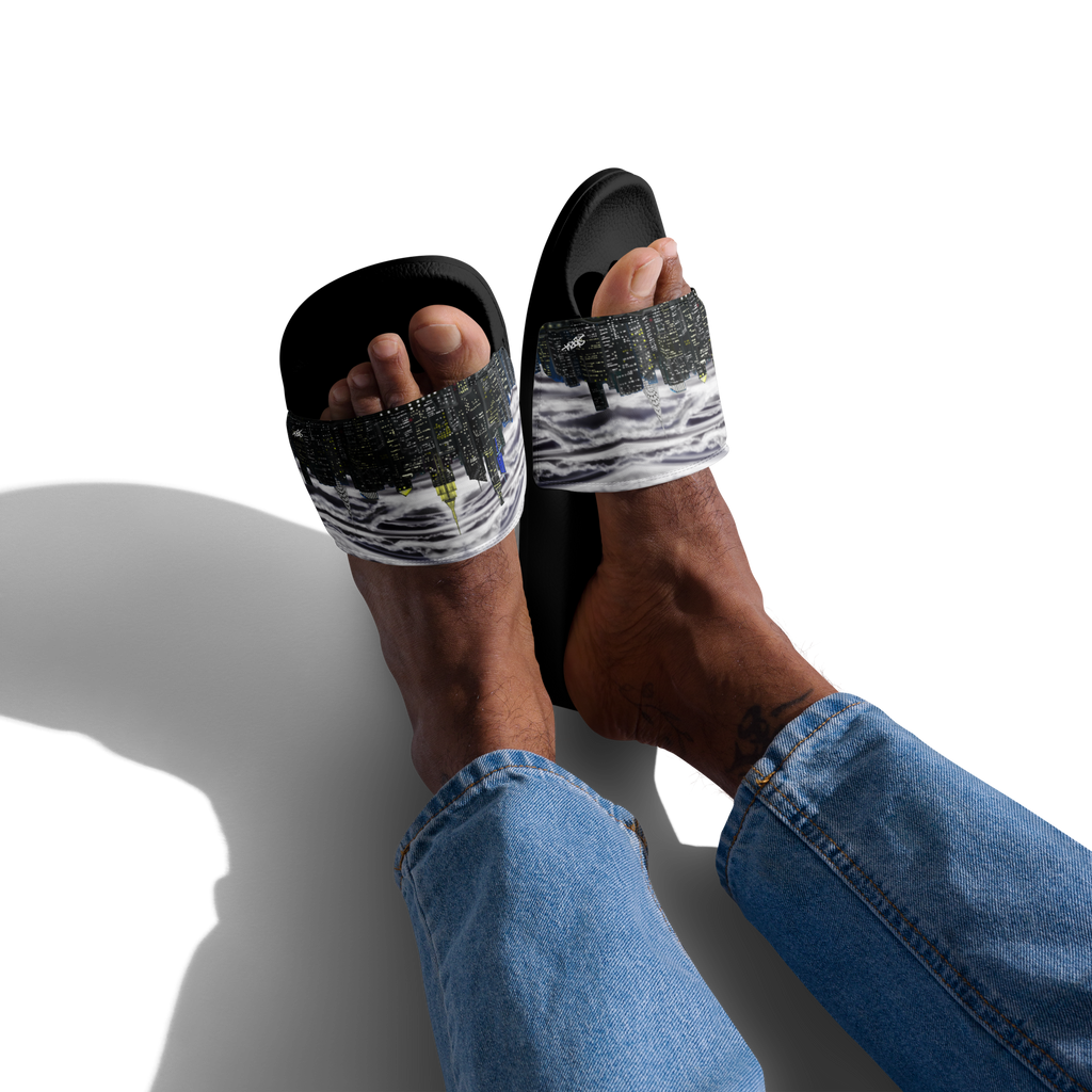 Black sandals with white Loria NYC Art worn by a person on a white background