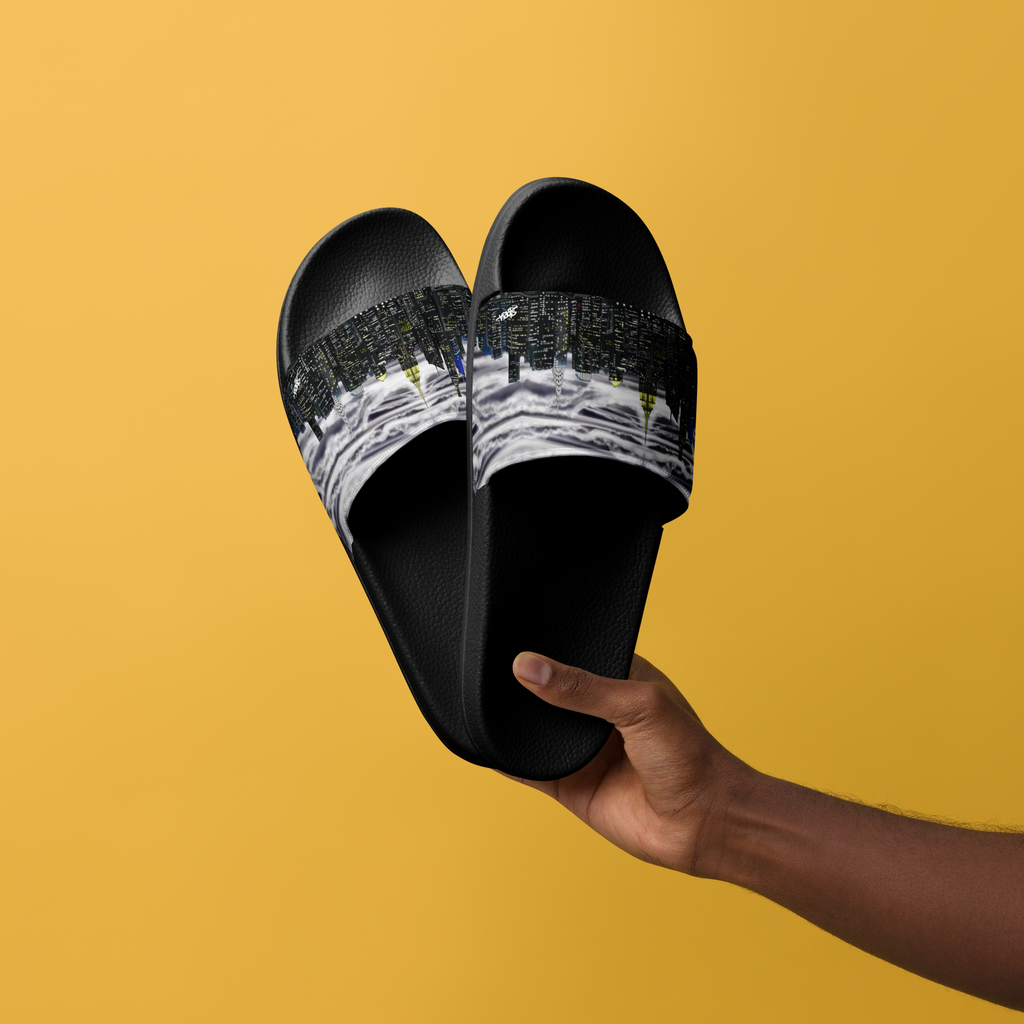 Black slides with Loria NYC Art cityscape design held by a hand against a mustard yellow background