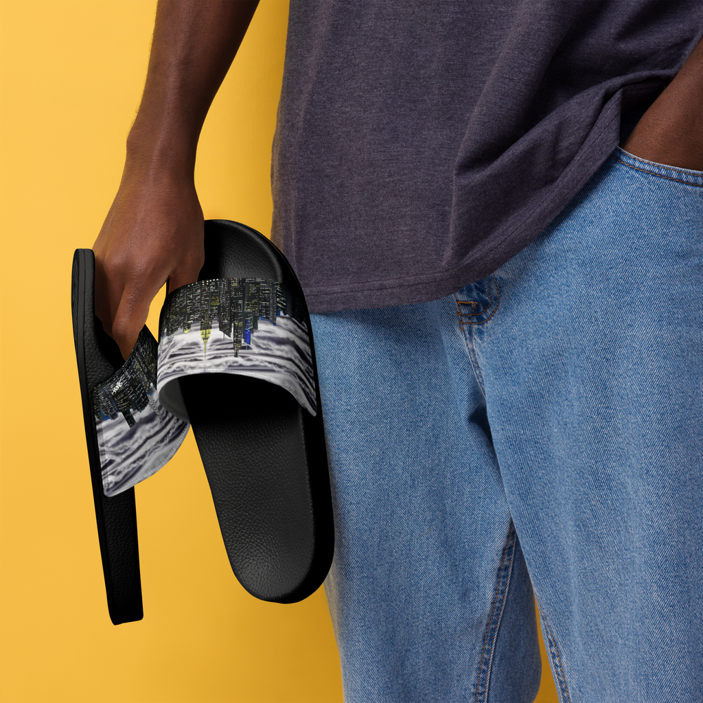 Person holding a black Loria NYC Art sandal with a graphic design on a yellow background