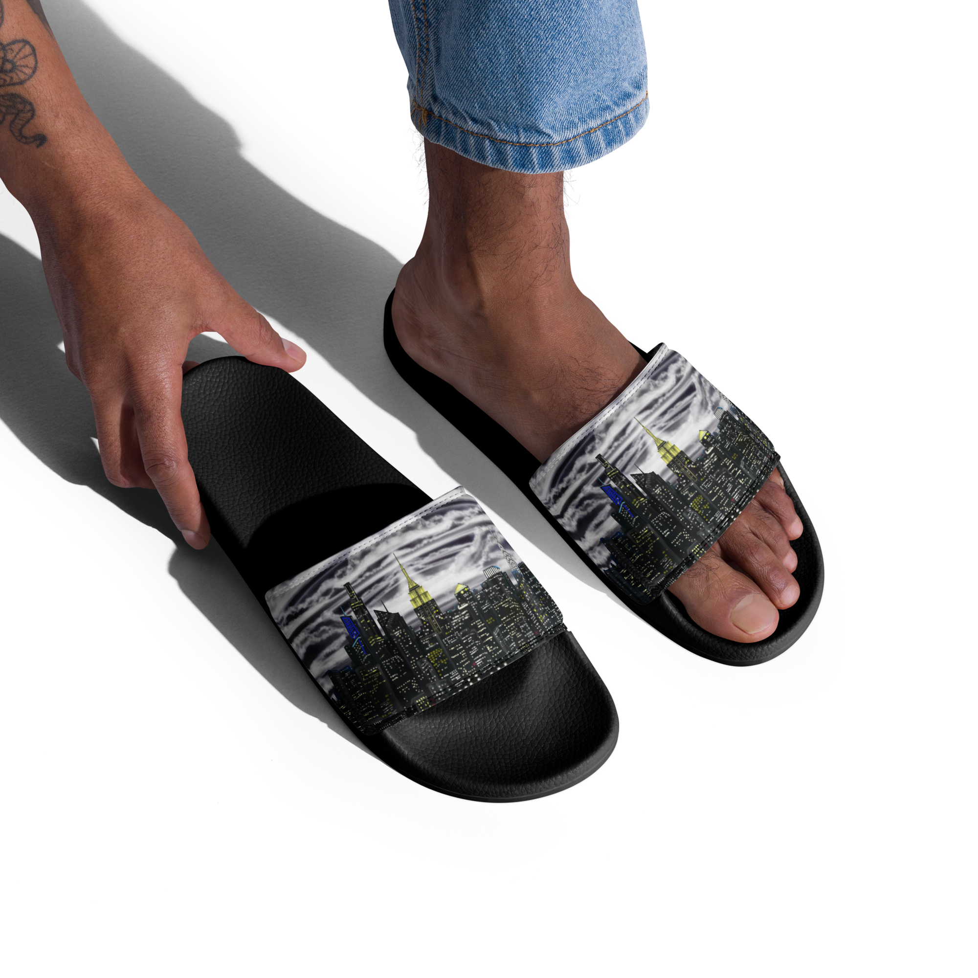 Black Loria NYC Art slides with a patterned strap worn by a person on a white background