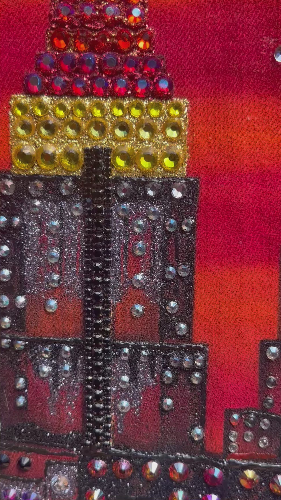 Video of a Loria NYC Art Artistic depiction of a city skyline with a red sky on a jacket