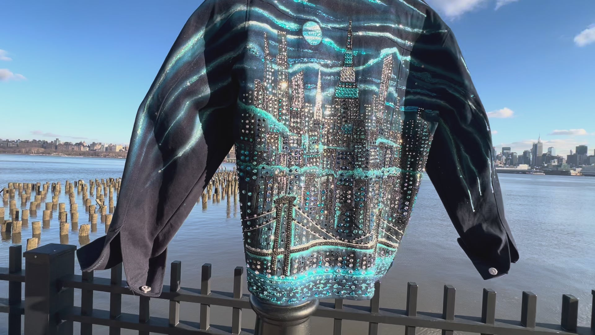 Side and Back video of denim jacket covered in Loria NYC Art with colorful skyline on a sunny day