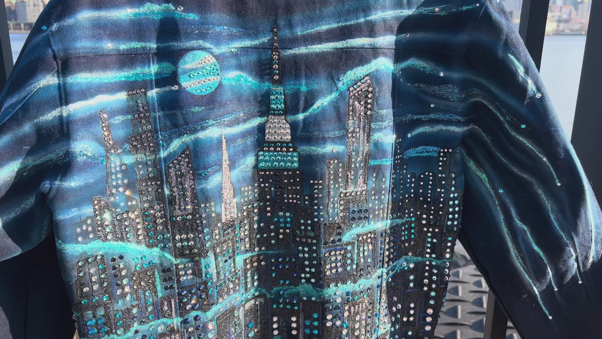 Up close Video  of a  jacket covered in Loria NYC Art with skyline background
