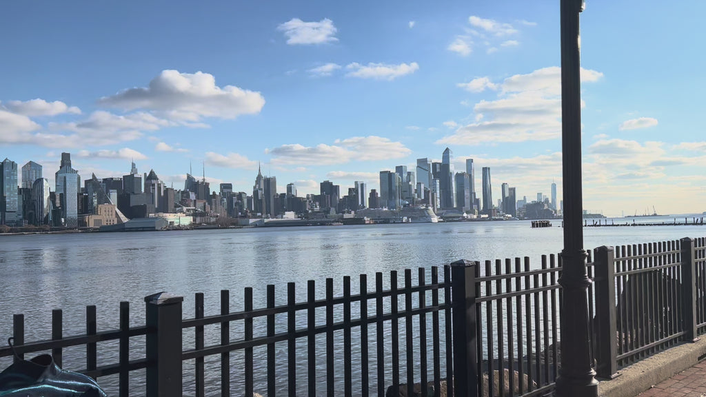 Back of detailed craft on blue denim jacket covered in Loria NYC Art with  skyline background 