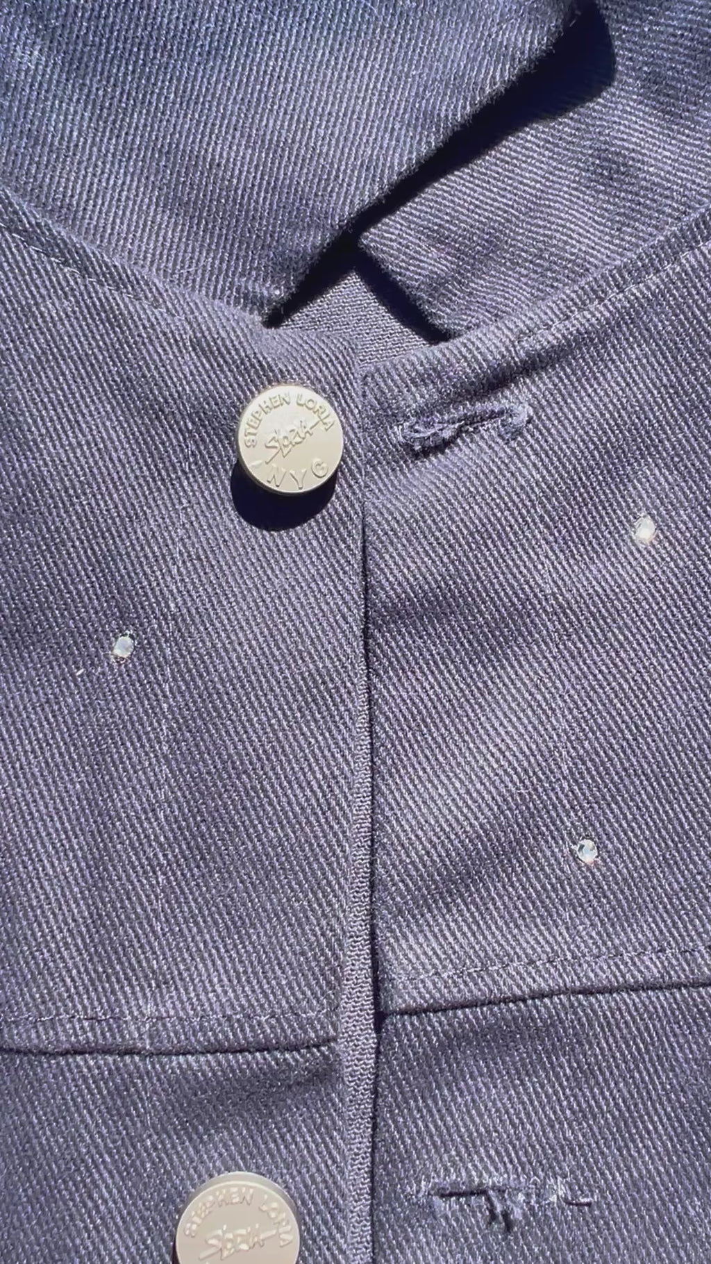 Front of blue Loria NYC Art jacket with crystals on a white background.
