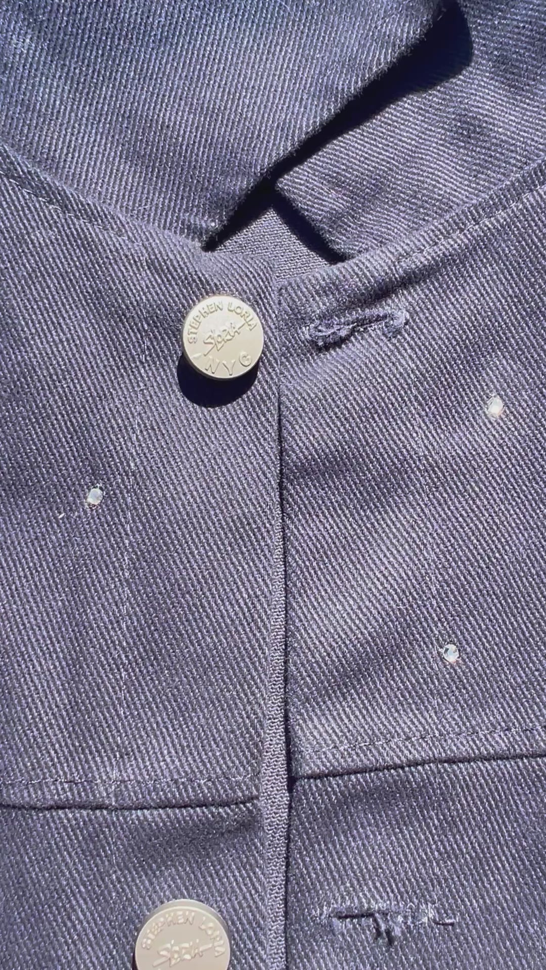 Front of blue Loria NYC Art jacket with crystals on a white background.