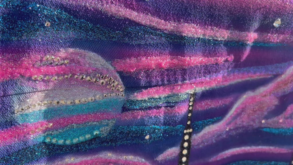 Close up Video of a detailed blue and pink  Loria NYC Art jacket with the city skyline in the background 