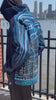 Blue jacket with Loria NYC Art on the back with the city skyline in the background.