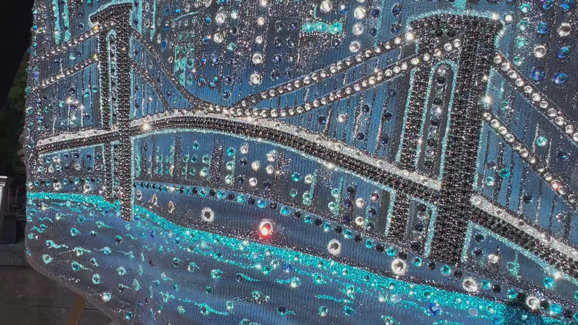 Video of Blue jacket with a cityscape Loria NYC Art design with a bridge.