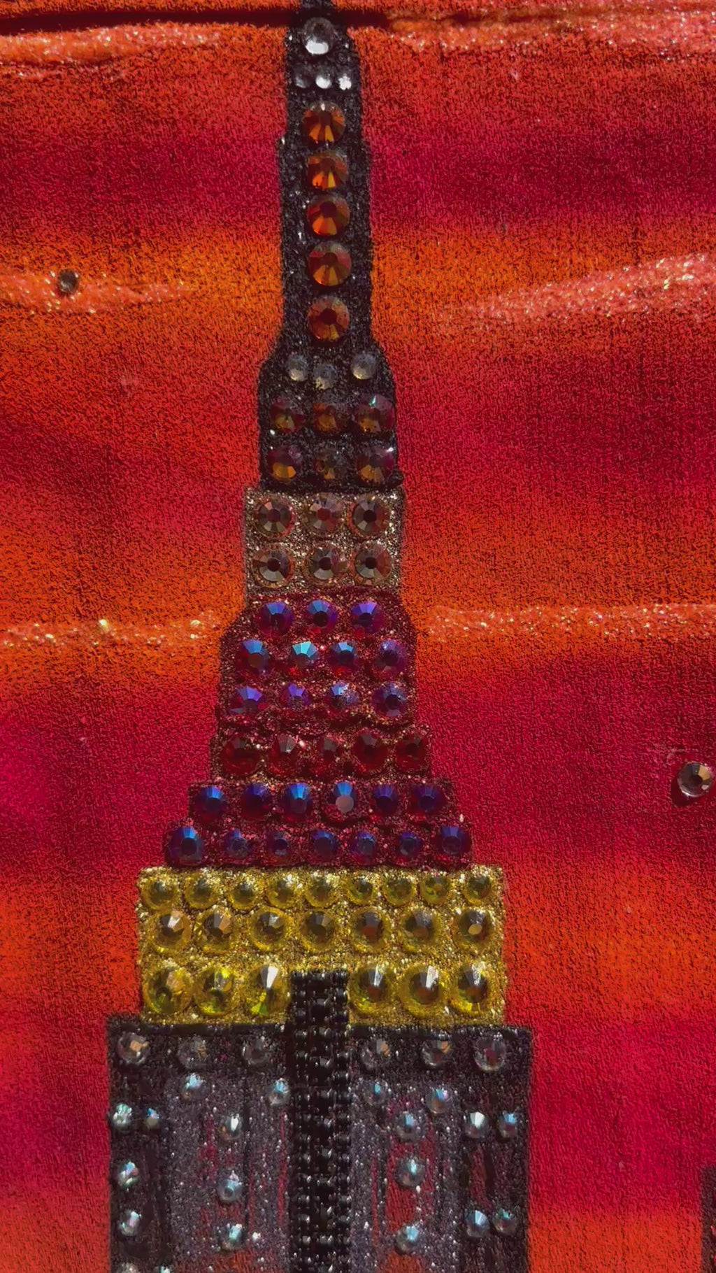 Video of a orange red jacket with Loria NYC Art in detail 