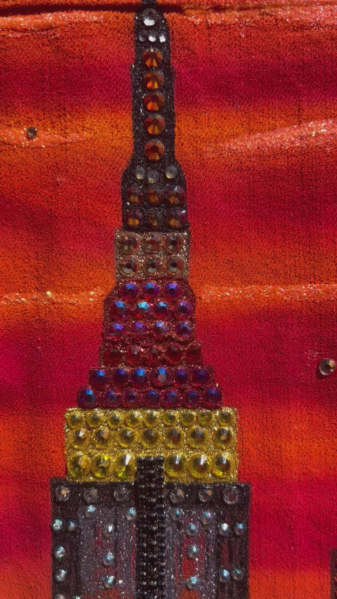 Video of a orange red jacket with Loria NYC Art in detail 