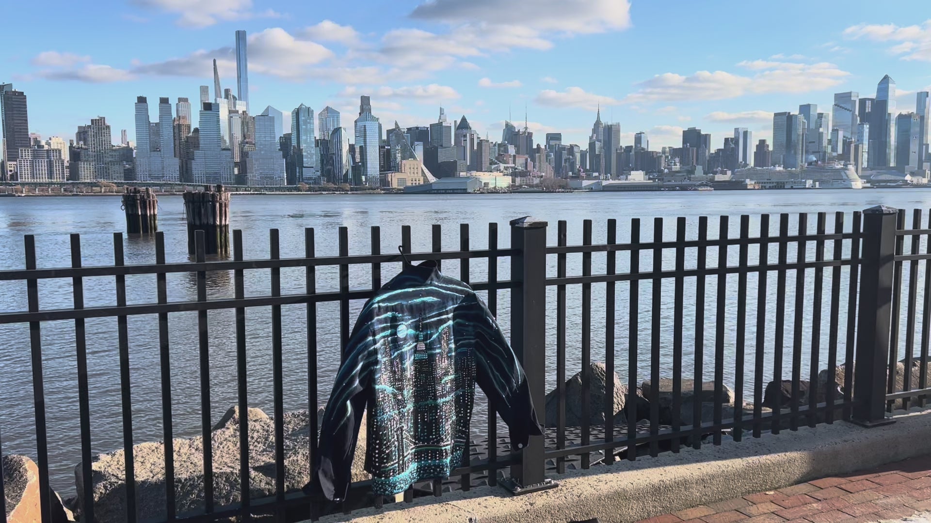 Sunny day view Back of denim jacket covered in Loria NYC Art with colorful skyline 