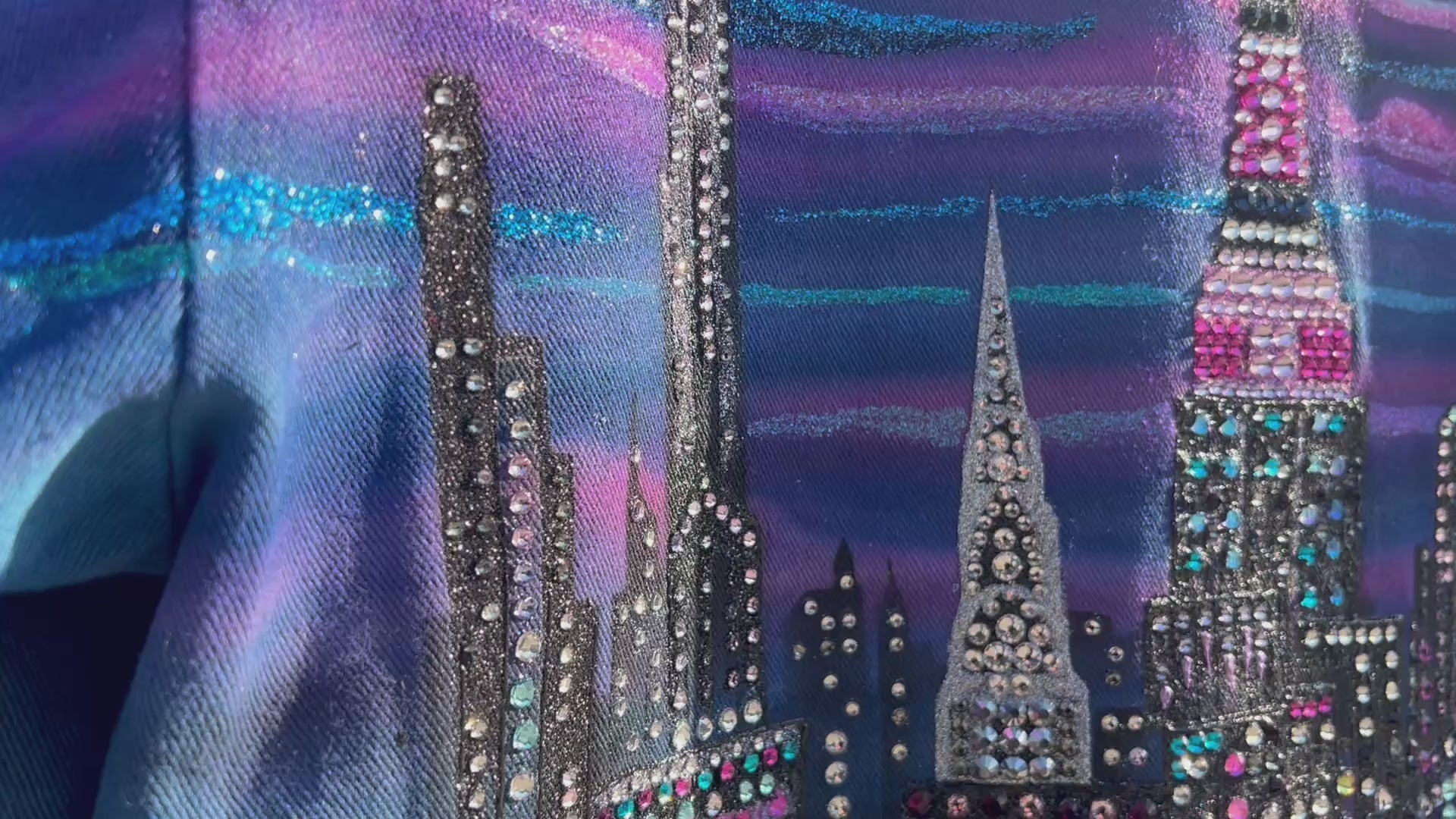 Video of a unique colorful Loria NYC Art jacket with the city skyline in the background 
