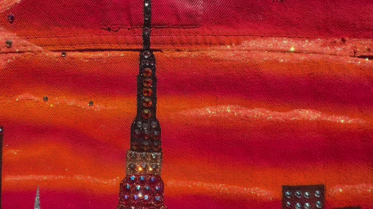 Video clip of  Loria NYC Art on a red orange jacket with crystals glistening 