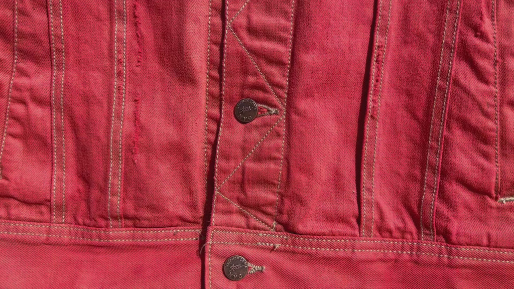 Video clip of a Front view of a Loria NYC Art jacket in a tomato color and custom buttons shown 