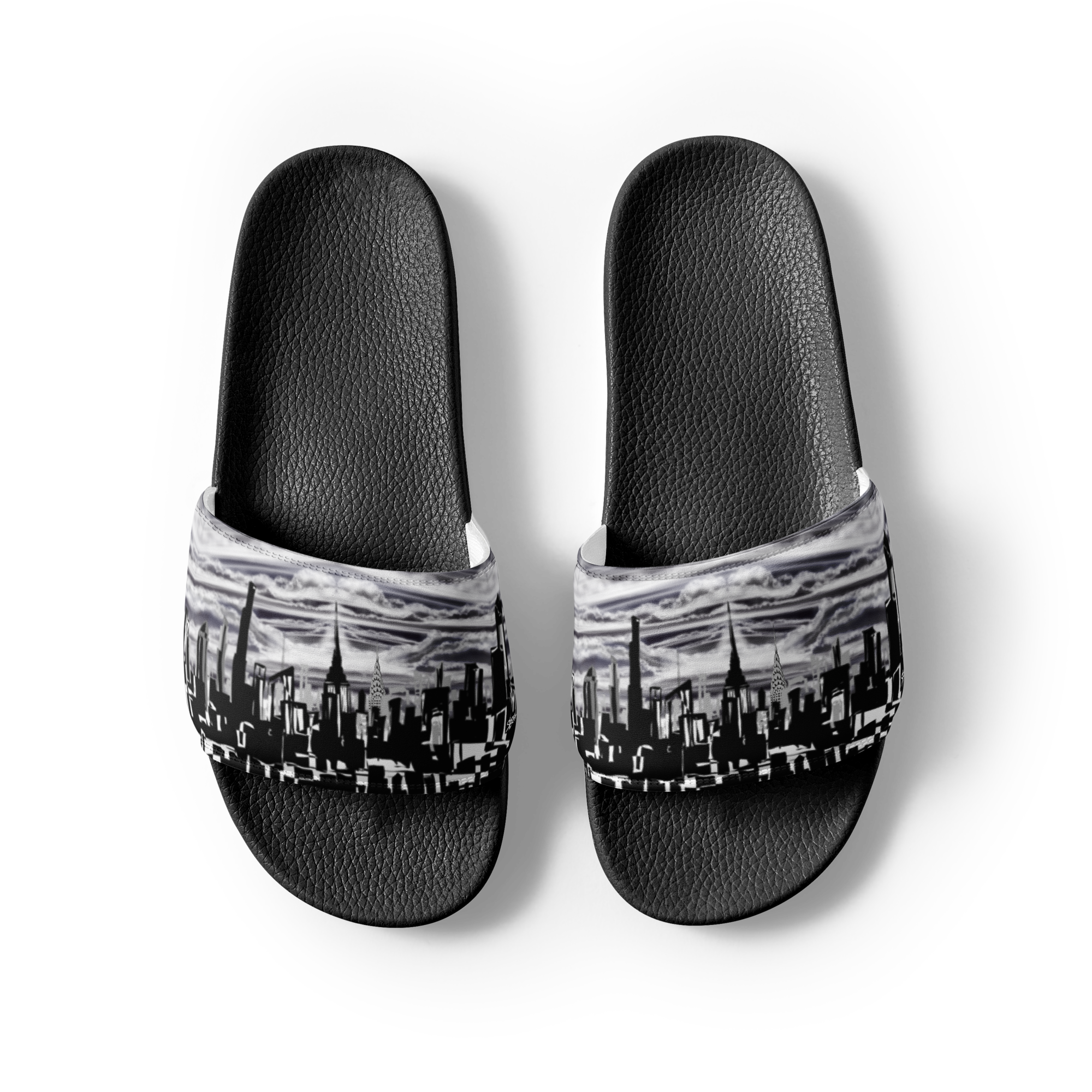 Black slide sandals with a Loria NYC Art cityscape design on a white background