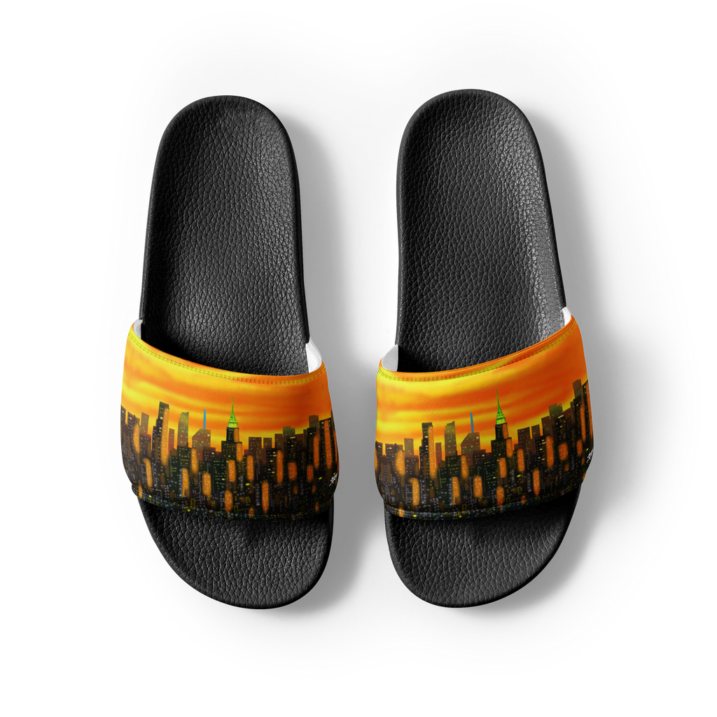 Black slide sandals with a Loria NYC Art cityscape design on an orange background