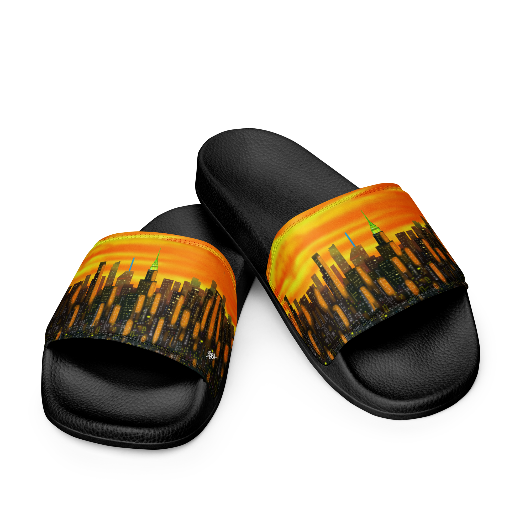 Black slide sandals with a Loria NYC Art cityscape design on a white background